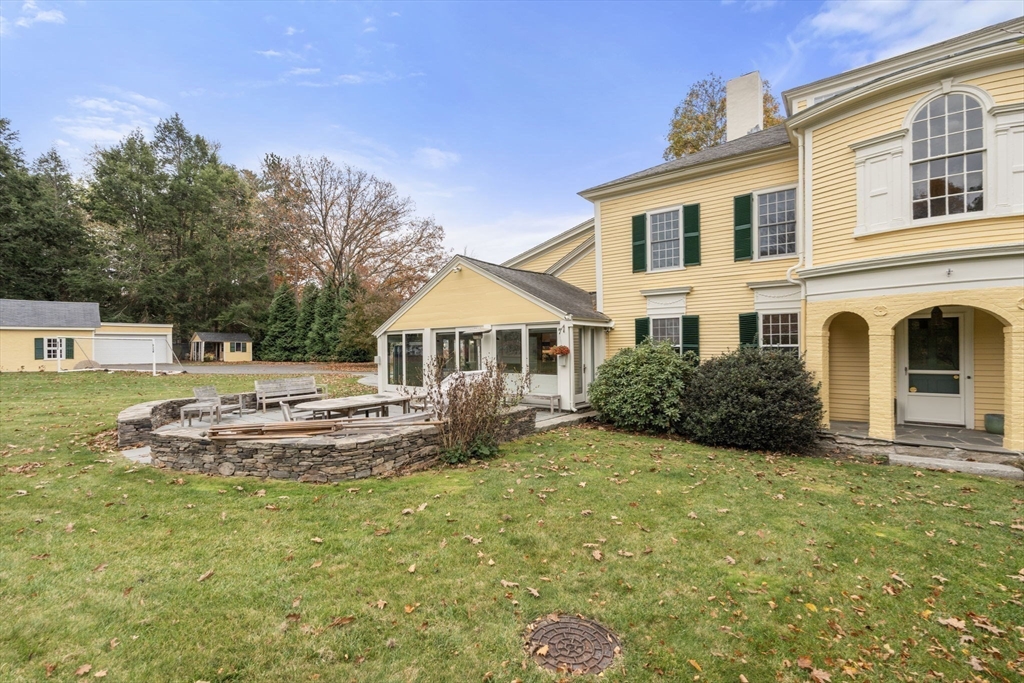221 Boston Post Road Wayland, MA 01778 - Photo 32 of 37 a front view of a house with a yard
