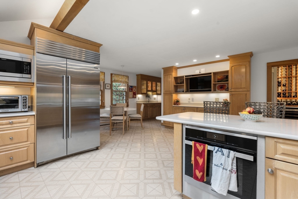 221 Boston Post Road Wayland, MA 01778 - Photo 9 of 37 a kitchen with stainless steel appliances granite countertop a stove and a refrigerator