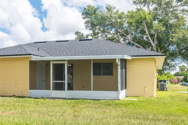 a view of a house with pool and garden