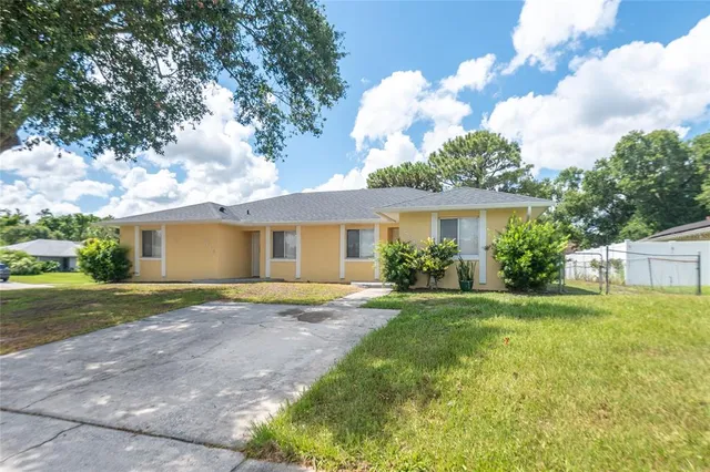 a front view of a house with a garden and yard
