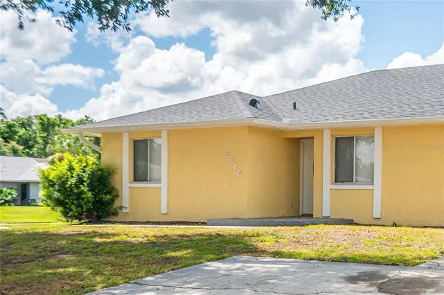 a view of a house with a backyard