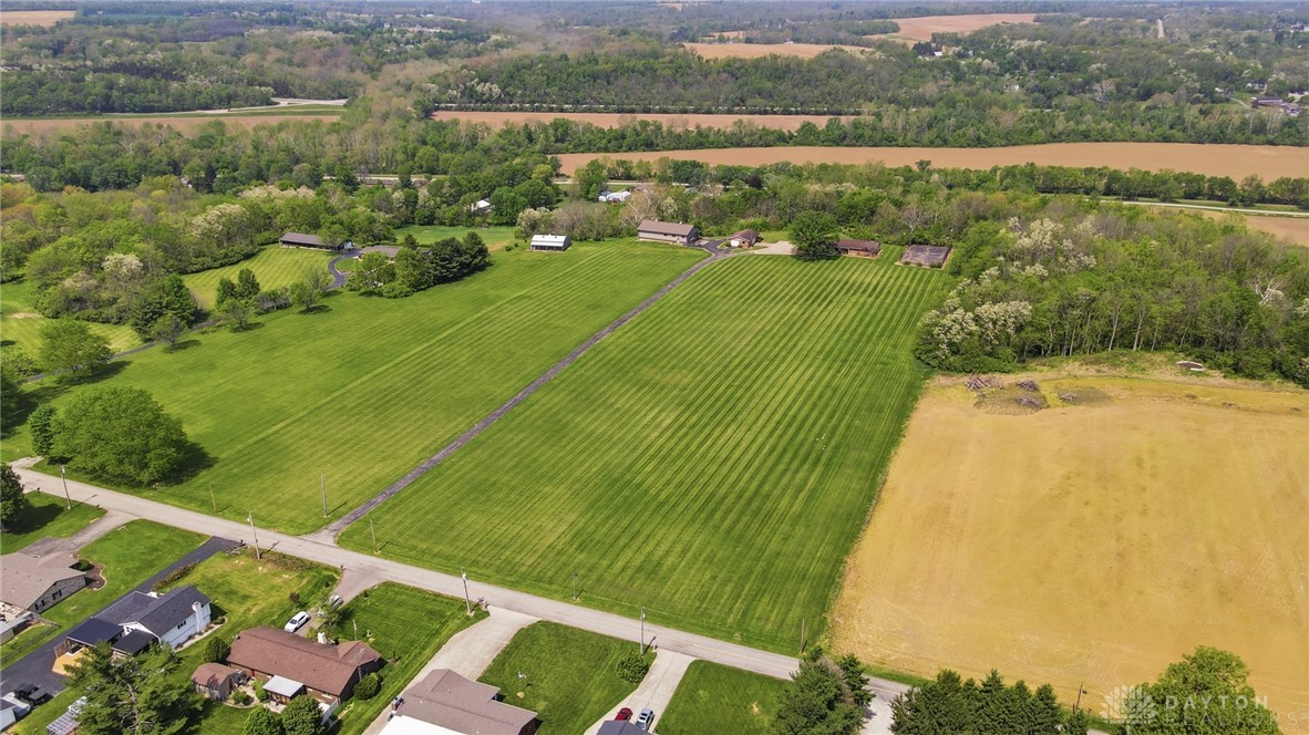 5669 O Neall Road Waynesville, OH 45068 - Photo 6 of 72 This aerial view showcases expansive green fields, mature trees, and a distant river.