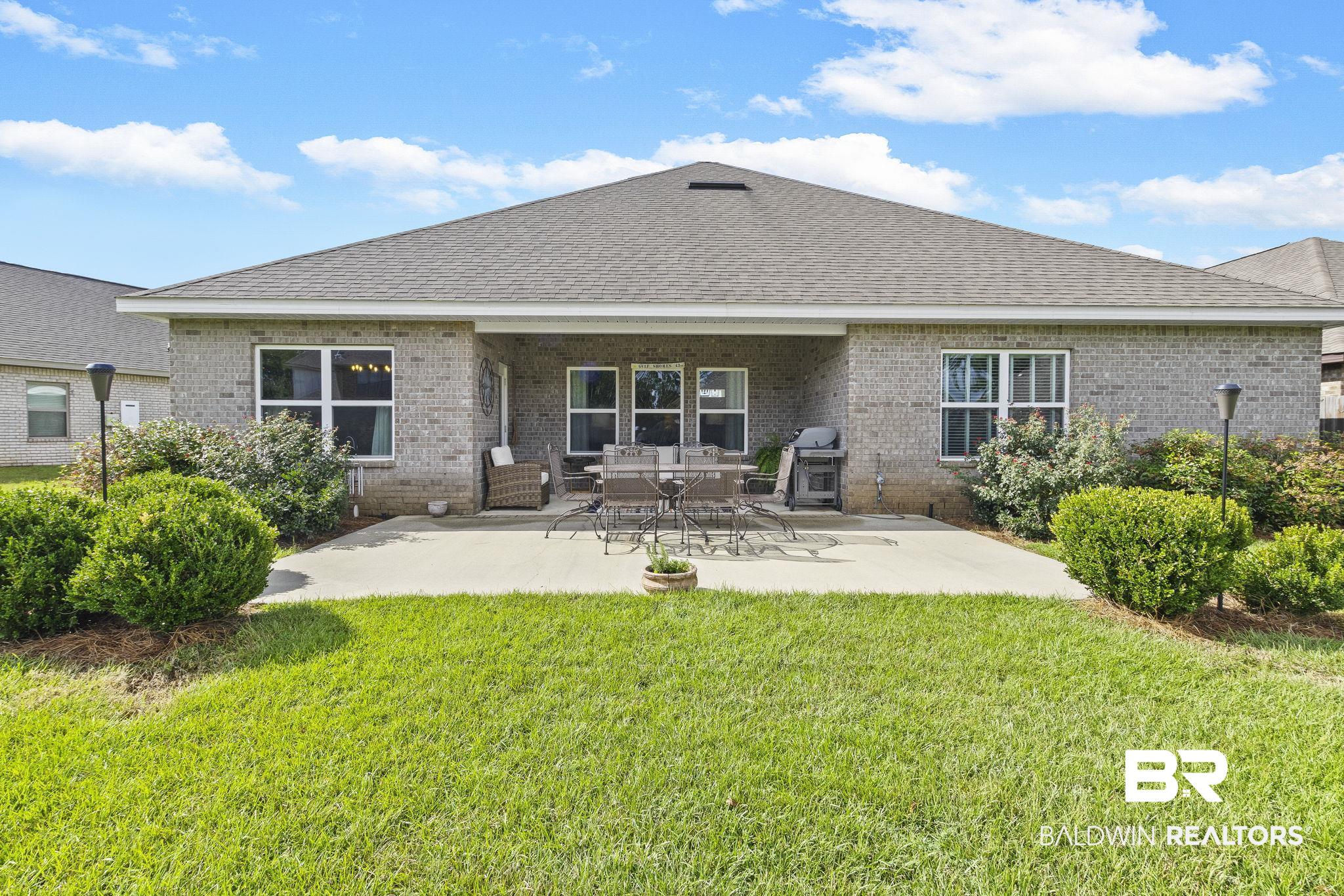 31663 Kestrel Loop Daphne, AL 36527 - Photo 56 of 86 Rear view of property with a patio area and a lawn