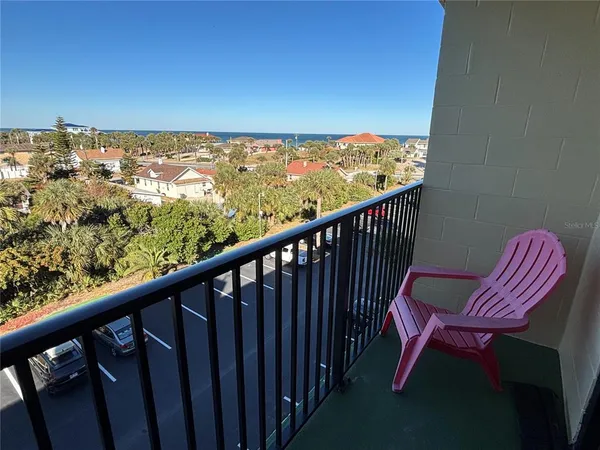 a view of a balcony with chairs