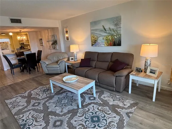 a living room with furniture and a lamp