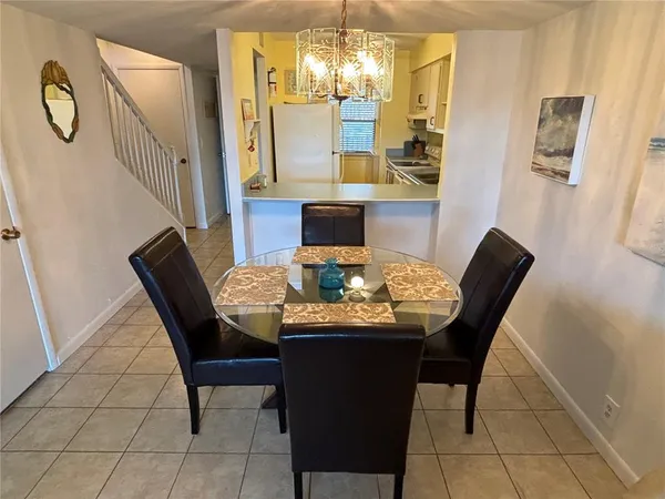 a view of a dining room with furniture and chandelier