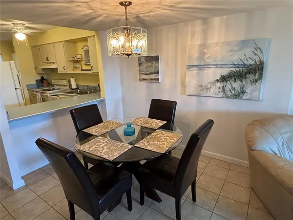 a view of a dining room with furniture and chandelier