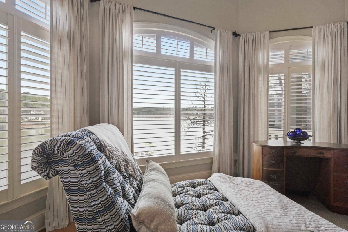 1691 Lighthouse Circle Greensboro, GA 30642 - Photo 27 of 75 a bedroom with a bed and a window