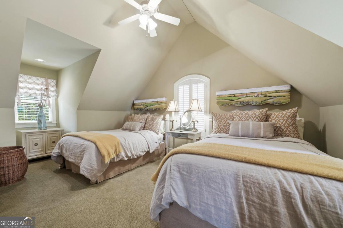 1691 Lighthouse Circle Greensboro, GA 30642 - Photo 44 of 75 a bedroom with two beds and a chandelier