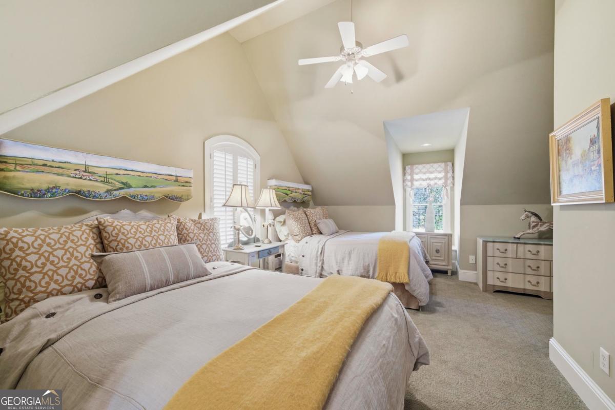 1691 Lighthouse Circle Greensboro, GA 30642 - Photo 45 of 75 a spacious bedroom with two beds and a chandelier