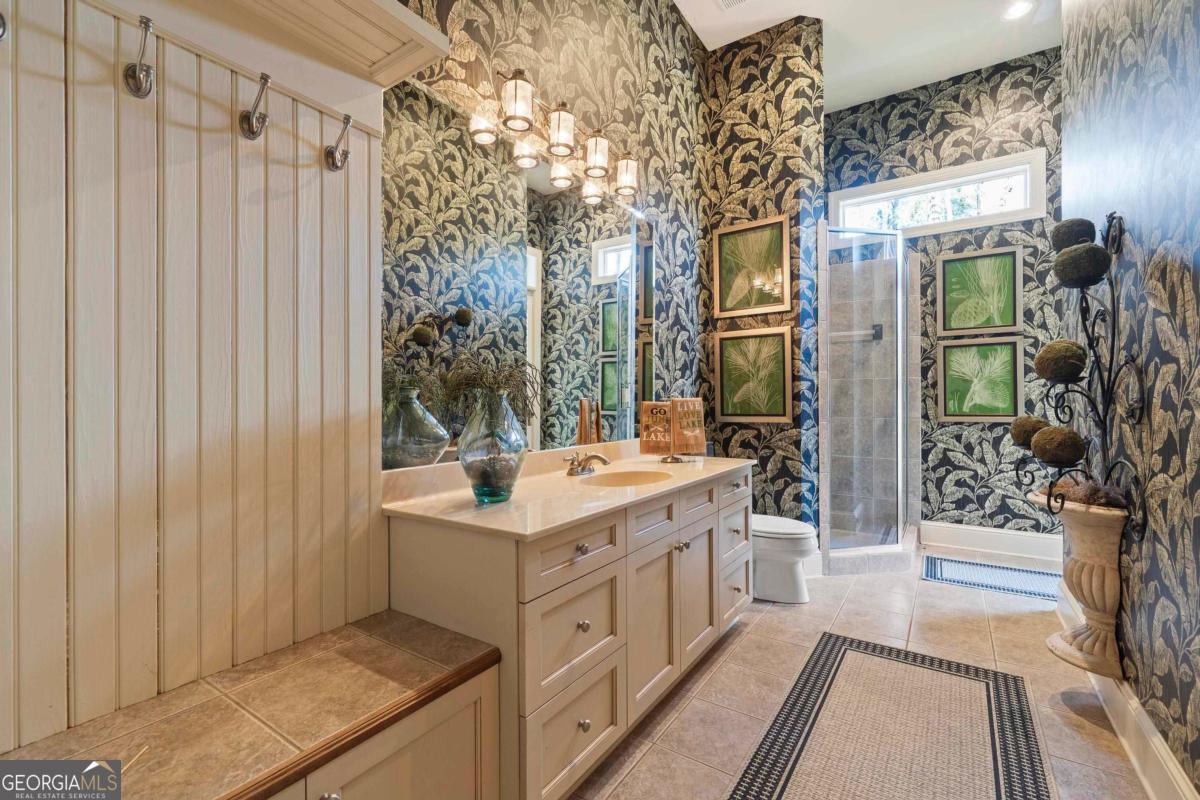 1691 Lighthouse Circle Greensboro, GA 30642 - Photo 59 of 75 a bathroom with a sink a mirror and a shower