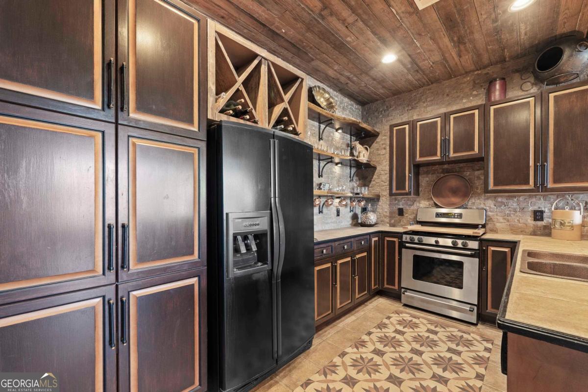 1691 Lighthouse Circle Greensboro, GA 30642 - Photo 62 of 75 a kitchen with stainless steel appliances granite countertop a refrigerator and a sink