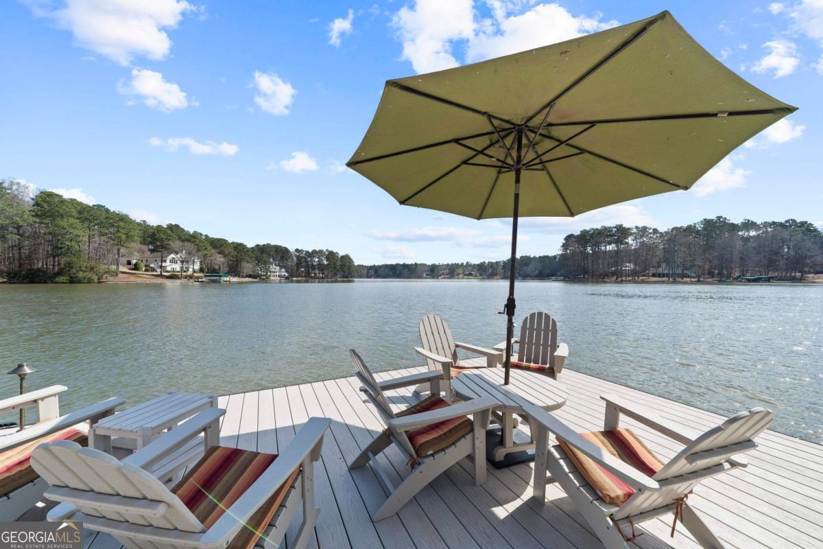 1691 Lighthouse Circle Greensboro, GA 30642 - Photo 69 of 75 a view of a lake with couches under an umbrella
