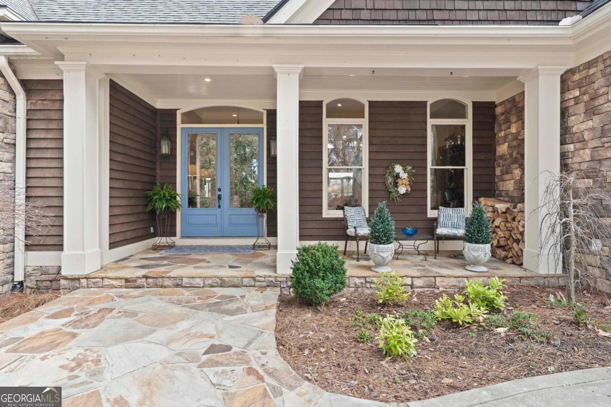 1691 Lighthouse Circle Greensboro, GA 30642 - Photo 7 of 75 a view of a house with potted plants and a small yard