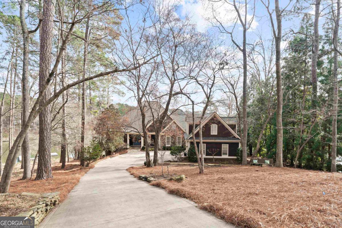 1691 Lighthouse Circle Greensboro, GA 30642 - Photo 8 of 75 a wooden house with trees in front of it