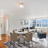 a dining room with furniture and wooden floor