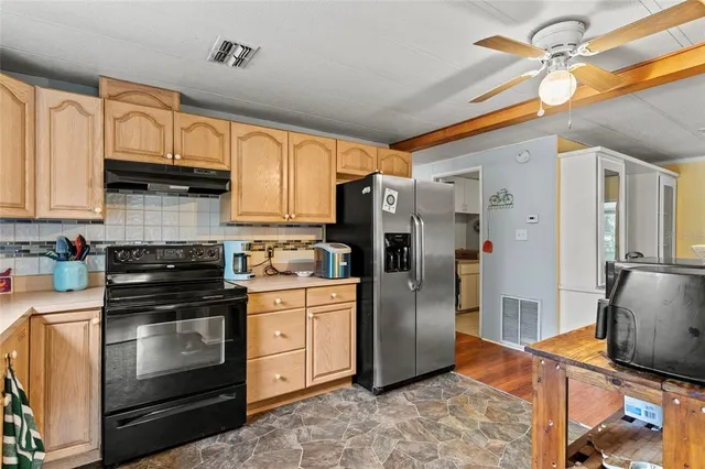 a kitchen with stainless steel appliances granite countertop a stove a refrigerator and a sink