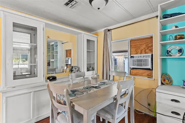 a dining room with furniture and window