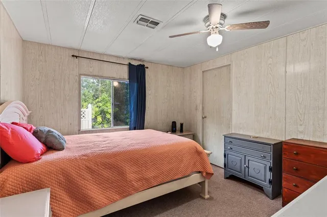 a bedroom with a large bed and a window