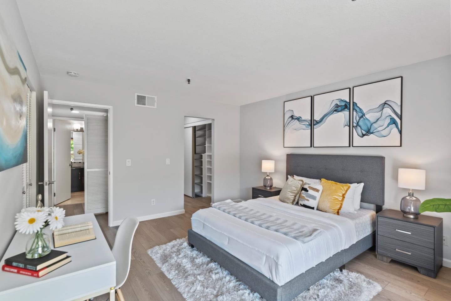 49 Showers Drive, Unit E250 Mountain View, CA 94040 - Photo 13 of 27 a bedroom with a bed and wooden floor