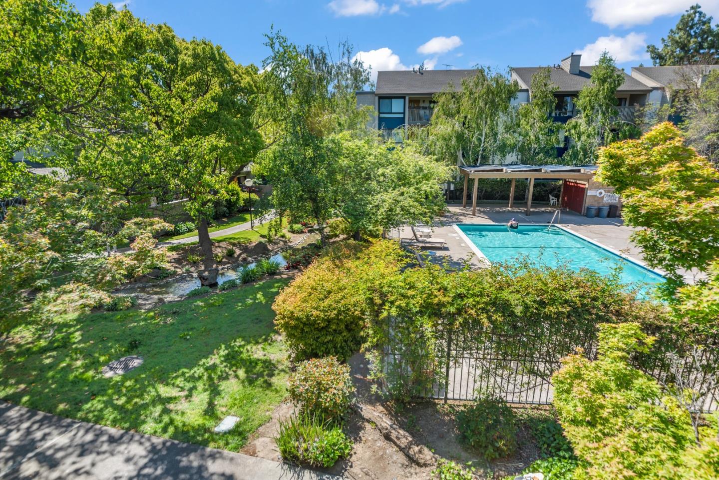 49 Showers Drive, Unit E250 Mountain View, CA 94040 - Photo 23 of 27 a view of a garden with plants and a fountain
