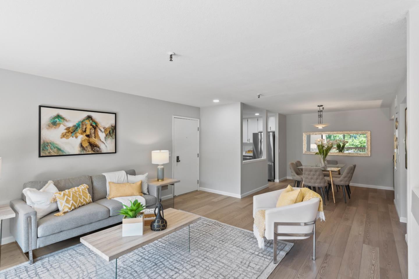 49 Showers Drive, Unit E250 Mountain View, CA 94040 - Photo 5 of 27 a living room with furniture and a dining table with wooden floor