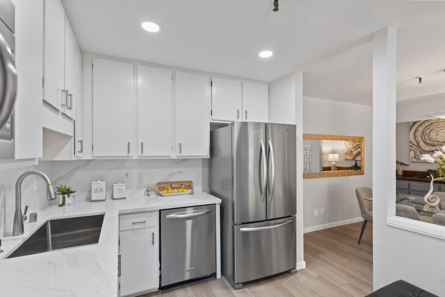 49 Showers Drive, Unit E250 Mountain View, CA 94040 - Photo 10 of 27 a kitchen with stainless steel appliances granite countertop a refrigerator sink and stove