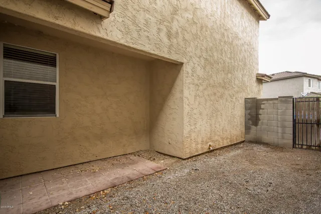 a view of backyard with brick wall