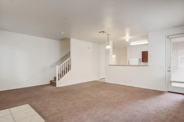 a view of an empty room with a kitchen