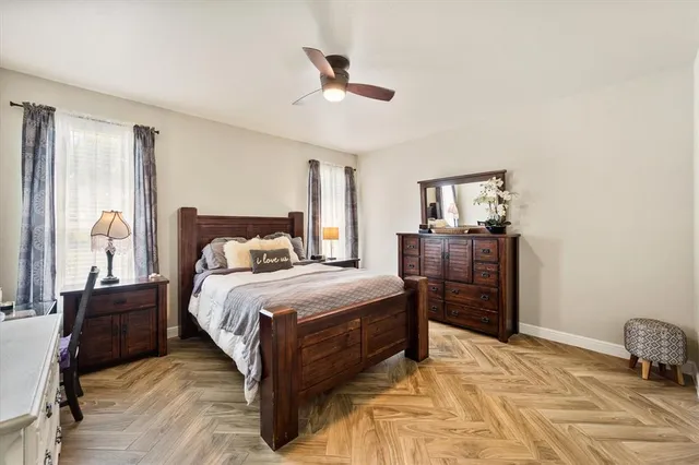a bedroom with a bed and wooden floor