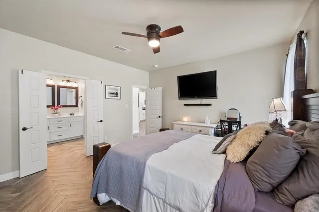 a bedroom with a bed and a flat screen tv