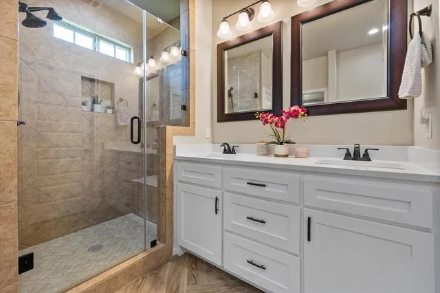 a bathroom with a shower sink and mirror