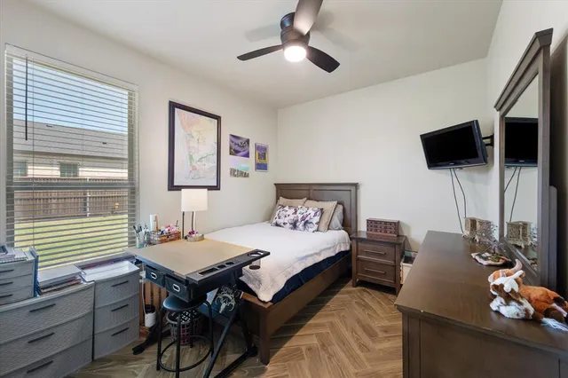 a bedroom with a bed and a flat screen tv