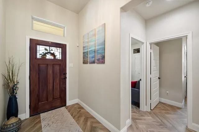 a view of elevator with hallway and front door