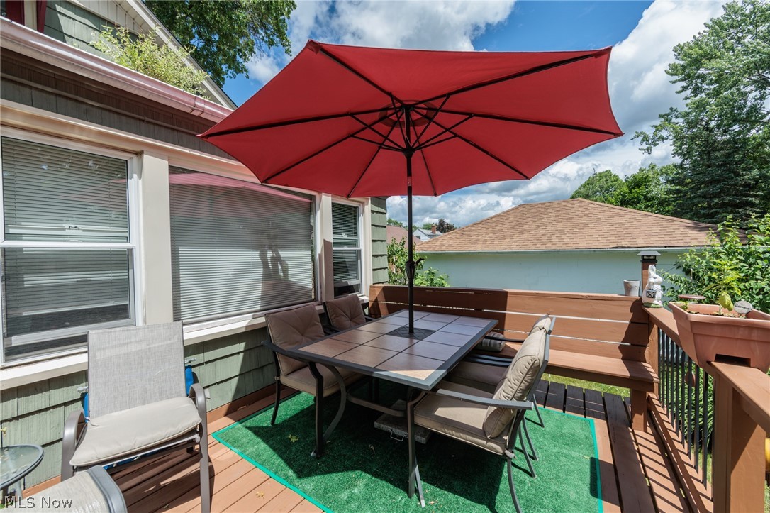 5364 Summit Road Lyndhurst, OH 44124 - Photo 40 of 42 Outdoor deck featuring wood-finish flooring, a built-in wood-finish bench, and wood-finish railings with black metal spindles