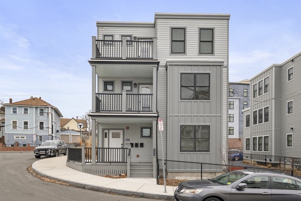 25 Hillsboro Street, Unit 1 Boston, MA 02125 - Photo 13 of 14 a front view of a residential apartment building with a yard