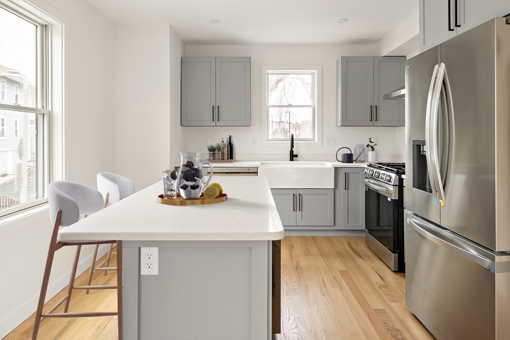 25 Hillsboro Street, Unit 1 Boston, MA 02125 - Photo 3 of 14 a kitchen with a sink appliances and windows