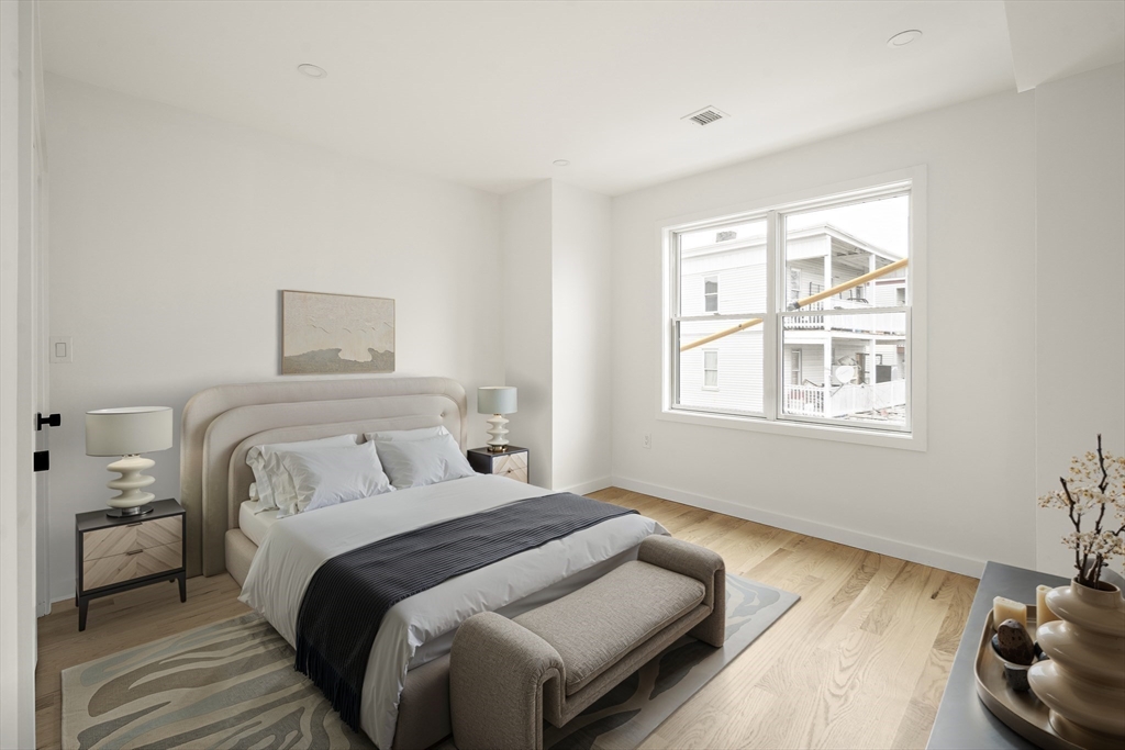25 Hillsboro Street, Unit 1 Boston, MA 02125 - Photo 6 of 14 a bedroom with a bed and a window