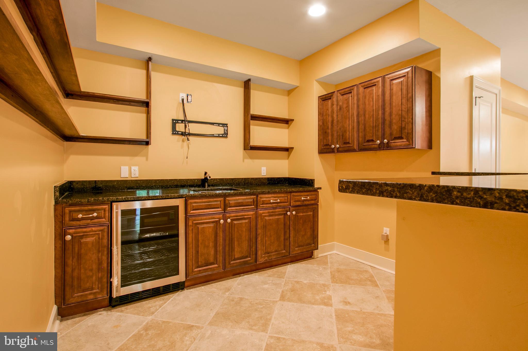 16434 Oak Hill Road Silver Spring, MD 20905 - Photo 77 of 90 a kitchen with stainless steel appliances granite countertop a stove a sink and a microwave