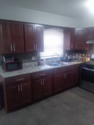a kitchen with stainless steel appliances granite countertop wooden cabinets a sink and dishwasher