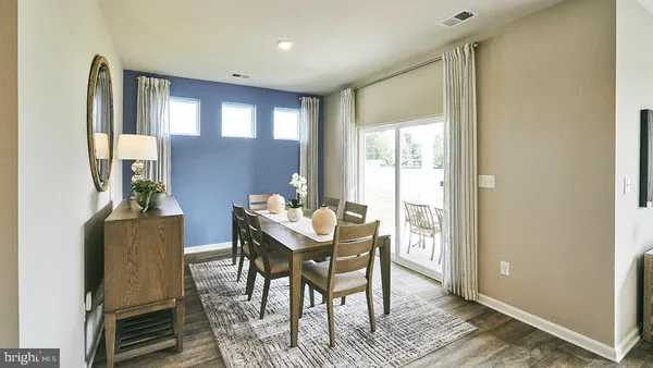 a kitchen with stainless steel appliances kitchen island granite countertop a refrigerator a stove a microwave oven a sink with island and chairs