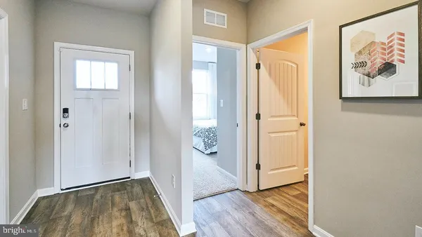 a view of an entryway with wooden floor