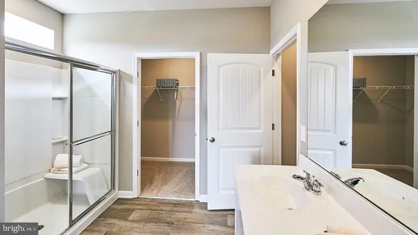 a en suite bathroom with a double vanity sink and a mirror