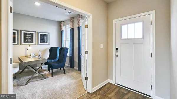 a view of a livingroom with furniture and a window