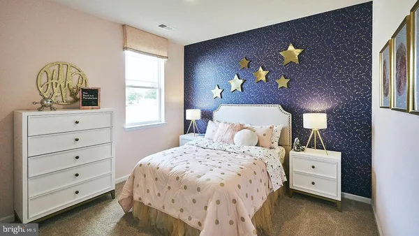 a large kitchen with stainless steel appliances kitchen island granite countertop a large window and a refrigerator