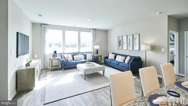 a view of a livingroom with furniture window and wooden floor