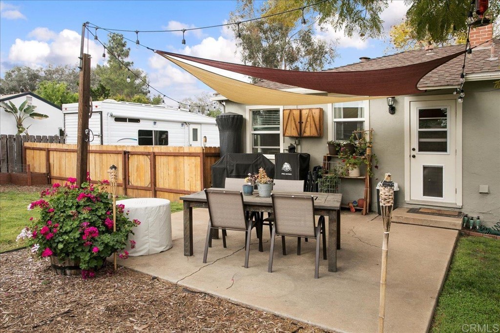 4989 Porter Hill Road La Mesa, CA 91942 - Photo 15 of 22 a view of a patio with a table and chairs potted plants
