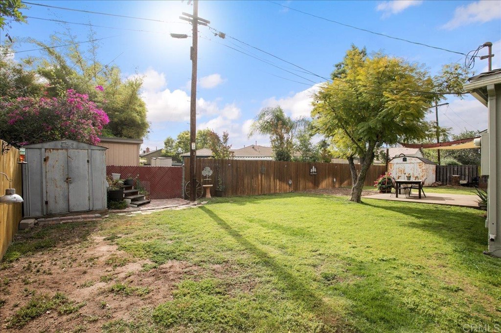 4989 Porter Hill Road La Mesa, CA 91942 - Photo 18 of 22 a view of a backyard with table and chairs plants and wooden fence