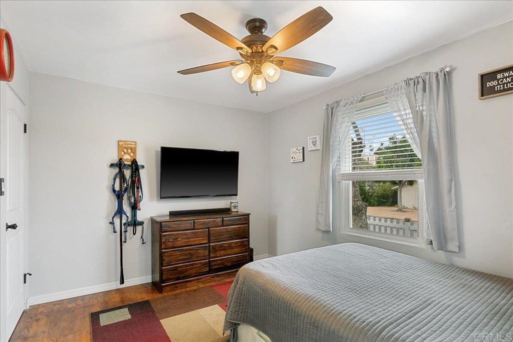 4989 Porter Hill Road La Mesa, CA 91942 - Photo 5 of 22 a bedroom with a bed and a flat screen tv