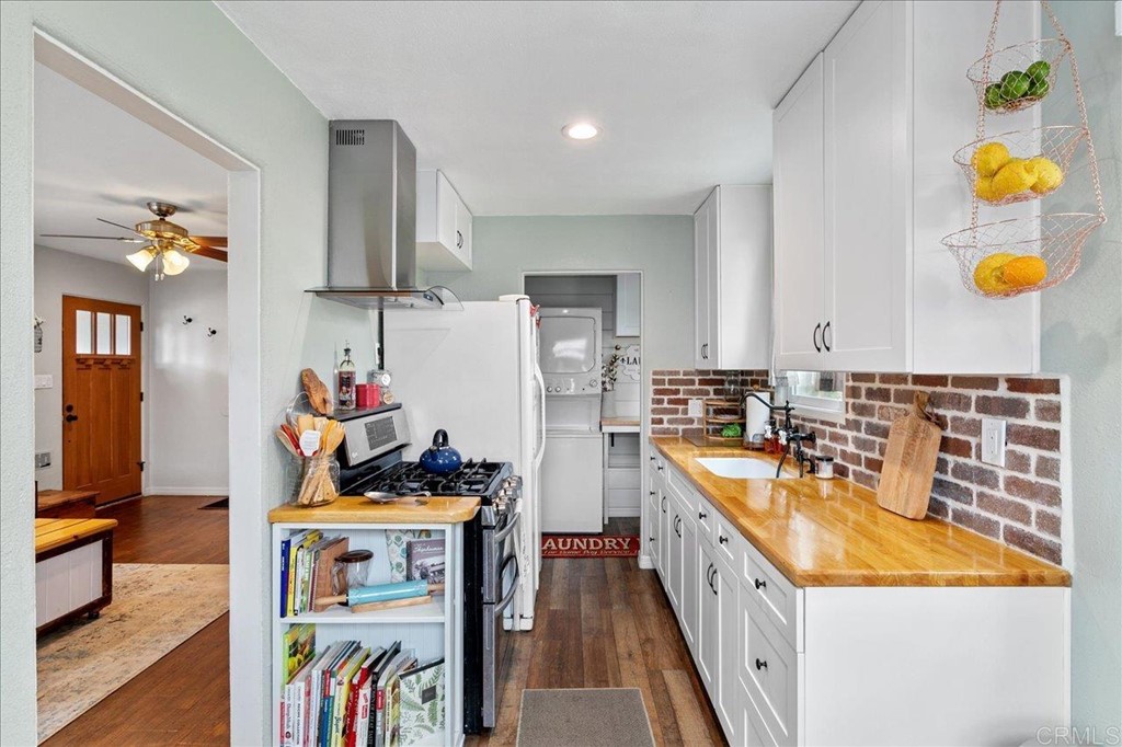4989 Porter Hill Road La Mesa, CA 91942 - Photo 9 of 22 a kitchen with stainless steel appliances granite countertop a sink a stove and a refrigerator